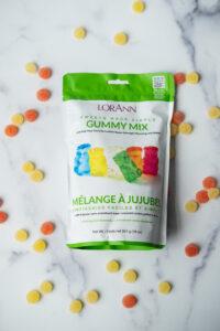 picture of Lorann Oils easy gummies mix, surrounded by loose gummies. 