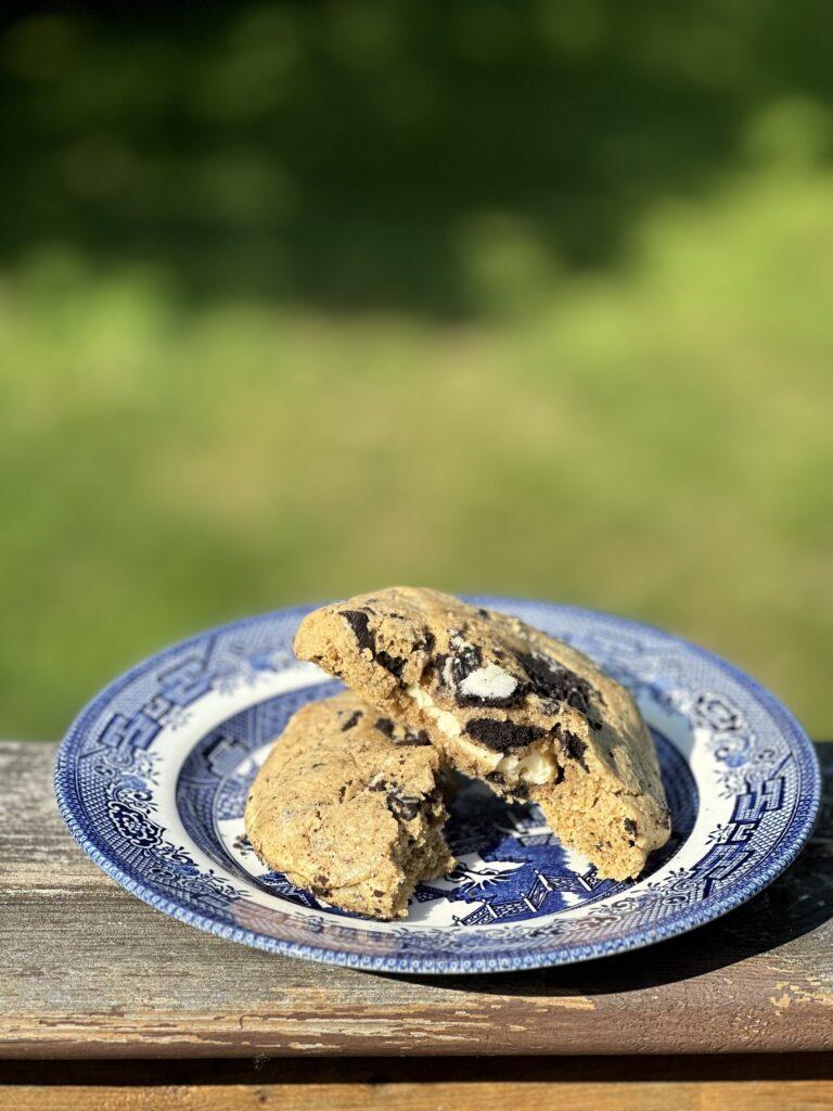 photo of an oreo cheesecake cookie on a plate, cut in half.