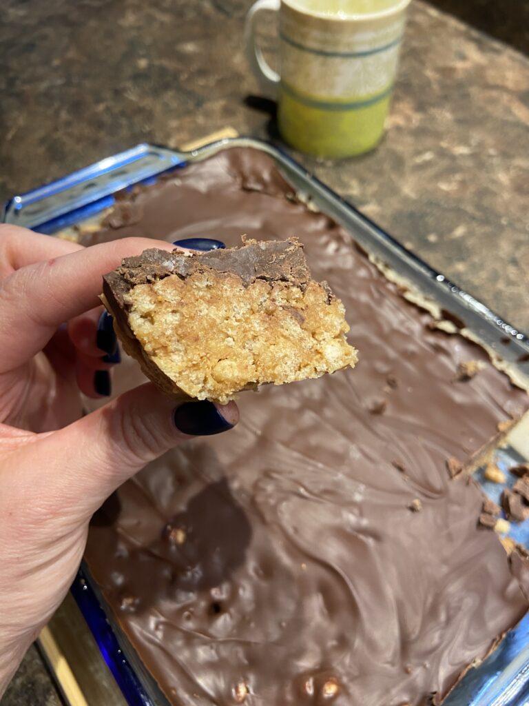 close up shot of a piece of cannabis infused schotcheroos with the whole pan in the background