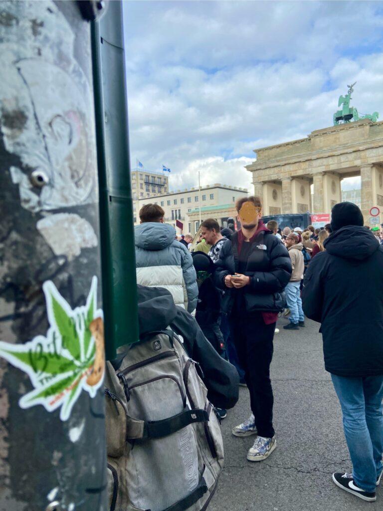 a photo of a bite me sticker with the bradenberg gate in the background on 420, the first celebration of german cannabis legalization