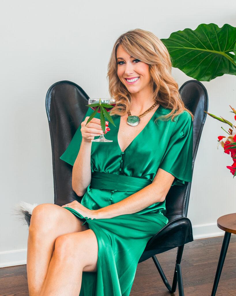 photo of Jamie Evans The Herb Somm holding a wine glass with a cannabis left in it.